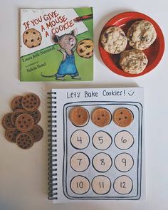 a book, cookie cookies and a notebook on a table