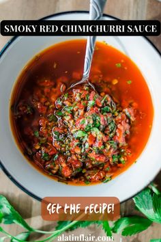 a bowl of smoky red chimiccuri sauce with a spoon in it and the words get the recipe below