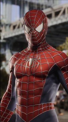 the amazing spider - man is standing in front of a cityscape with his hands on his hips