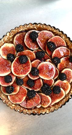 a pie topped with sliced figs and blackberries