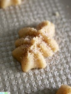 some food that is sitting on top of a metal pan and covered in powdered sugar