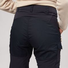 Fjallraven's Nikka Curved Trouser has the same technical features and benefits as their Nikka Trouser but is built with more room in the hips, thighs, and waist for a more comfortable feel. The pre-shaped knees and stretch panels provide you with freedom of movement in case you come across any obstacles on the trail. Designed for long treks and weather that might get a little wet, the quick-drying, wicking material will help keep you dry. The G-1000 fabric has also been wax-treated for increased Full-length Bottoms With Hip Pockets For Outdoor Activities, Outdoor Full-length Bottoms With Hip Pockets, Functional Hiking Bottoms With Pockets, Fitted Bottoms With Hip Pockets For Outdoor, Fitted Outdoor Bottoms With Hip Pockets, Functional Fitted Hiking Bottoms, Functional Fitted Pants For Hiking, Practical Outdoor Work Bottoms With Hip Pockets, Practical Bottoms With Hip Pockets For Outdoor Work