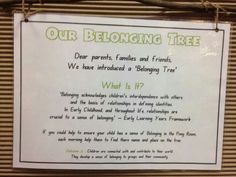 a sign hanging on the side of a building that says, our belonging tree dear parents, families and friends we have introduced a belong tree