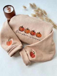 🎃 Pumpkin Season Embroidered Sweatshirt With Embroidered Sleeves - Cozy Fall Vibes 🎃 🍁 Embrace the beauty of autumn with this soft and stylish sweatshirt, featuring a charming Pumpkin Season embroidered design. Perfect for cozy nights, fall adventures, or pumpkin patch visits, this sweatshirt is a must-have for pumpkin lovers and fall enthusiasts alike! 🍂 Product Highlights: 🧡 High-quality embroidery: Features four adorable pumpkins with a handwritten "Pumpkin Season" design, and cute embro Long Sleeve T-shirt With Embroidered Graphics For Fall, Fall Long Sleeve Sweatshirt With Custom Embroidery, Embroidered Long Sleeve Sweatshirt For Fall, Custom Embroidery Long Sleeve T-shirt For Fall, Fall Crew Neck Hoodie With Letter Embroidery, Crew Neck Top With Custom Embroidery For Fall, Long Sleeve Top With Letter Embroidery For Fall, Halloween Embroidered Crew Neck Hoodie, Halloween Embroidered Cotton Sweatshirt