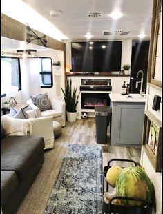 a living room filled with furniture and a flat screen tv mounted to the side of a wall