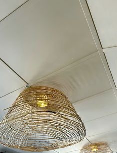 two lamps that are hanging from the ceiling