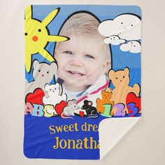 a blue blanket with a photo of a baby in the center and some cartoon characters on it