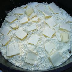 cheese and flour are mixed together in a pan on top of the stove burner