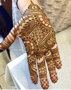 a woman's hand with henna on it