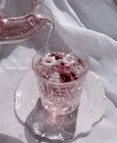 a glass pitcher filled with liquid on top of a plate