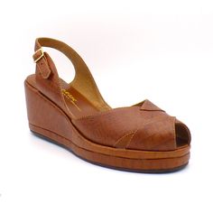 This sleek platform wedge sling back comes in beautiful embossed “crocodile” leather. Embossed crocodile leather uppers with a rubber sole 2 ½" wedge heel with 1" platform Imported Sizing The Taos comes in U.S. Women's whole sizes, 5-11. It runs true to size. Because it's a sling back, people who normally wear a half size are more likely to go down than up. Please consider the measurements of the Taos footbed length to determine your correct size. To measure your foot length, stand flat on a pie Evolution Of Fashion, Croc Leather, Shoe Repair, Peep Toe Shoes, Retro Shoes, Shoe Company, Taos, Crocodile Leather, Platform Wedge