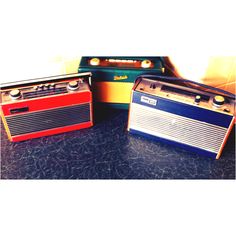 two old radio's sitting on top of a table