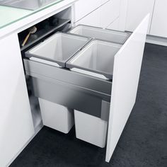 an open cabinet in the middle of a kitchen with white cabinets and countertop space