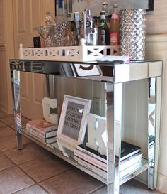 a mirrored table topped with books and drinks