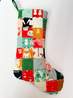 a colorful christmas stocking hanging on a white wall