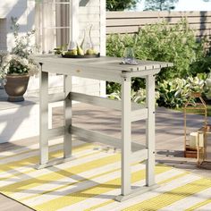 an outdoor table on a patio with potted plants