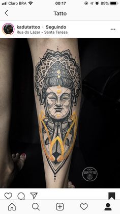 a woman's leg with tattoos on it and an image of a buddha in the middle