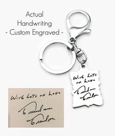 a keychain with handwriting on it next to a piece of paper that says, actual handwriting - custom engraved