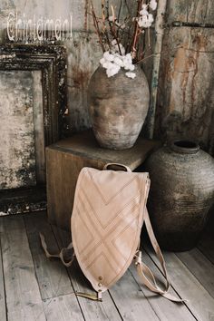 "⫸ We ship by EXPRESS EMS now for fast & safe delivery! Our unique shield shaped unisex boho backpack is a gorgeous artifact to carry your everyday necessities around. It is made out of double layered strong cotton canvas and decorated with huge solid brass feather pendant, as well, as geometric tribal protective stitching. The straps are regulated with beautiful brass rings and can be adjusted in length for your convenience. There are two secure small zipped pockets for valuables and gadget Bohemian Beige Backpack, Bohemian Backpack With Adjustable Strap For Festivals, Bohemian Backpack For Everyday Use, Bohemian Leather Backpack For Daily Use, Bohemian Leather Backpack For Everyday, Bohemian Leather Backpack For Everyday Use, Bohemian Satchel Backpack For Everyday Use, Bohemian Leather Backpack With Adjustable Strap, Everyday Bohemian Leather Backpack