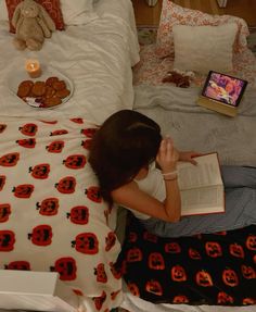 a girl reading a book on her bed