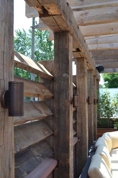 an outdoor area with wooden walls and benches