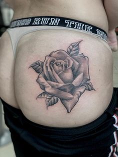 a woman's stomach with a rose tattoo on her belly and the words run this way