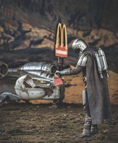 a man dressed as darth vader handing something to another person