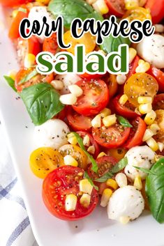 a white plate topped with tomatoes, corn and mozzarella salad next to a blue checkered table cloth