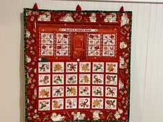 a red quilt hanging on the wall