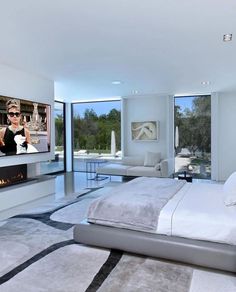 a bedroom with a large bed and a flat screen tv