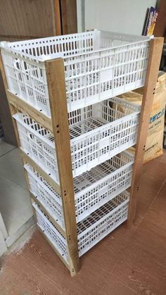 a wooden shelf filled with white baskets on top of a hard wood floor