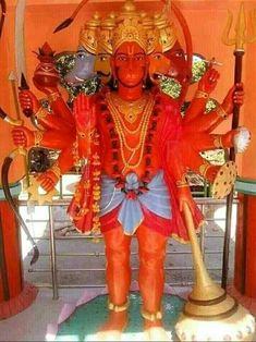 a statue of hindu god holding two spears