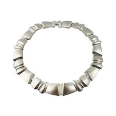 1980s Modernist silvertone collar necklace with fold-over clasp. Marked "Monet." Condition: Very Good; one tiny dimple. Measures: 6.63 inches L x 6.13 inches W. Modern Metal Choker For Formal Occasions, Silver Metal Formal Choker, Formal Silver Metal Choker, 1980s Fashion, Modern Branding, Collar Necklace, Mens Bracelet, Vintage Antiques, Silver Tone