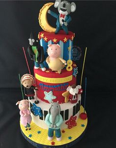 a three tiered cake decorated with cartoon characters and stars on it's sides