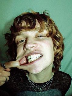 a young man making a funny face with his finger