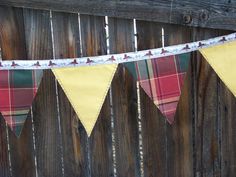 a plaid banner hanging on a wooden fence