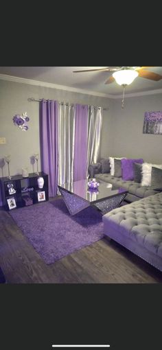 a living room filled with furniture and purple accents