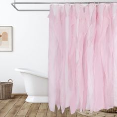 a pink shower curtain in a bathroom next to a bathtub and sink with a basket on the floor