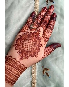 a henna on someone's hand with butterflies around it