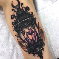 a woman's leg with a tattoo on it and a light fixture in the middle