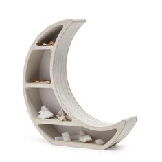 a white shelf with rocks on it and a half moon shaped shelf in the middle