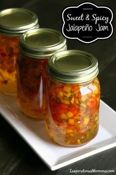 three mason jars filled with sweet and spicy jalapeno jam on a white plate