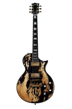 an old black and gold guitar on a white background