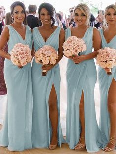 the bridesmaids are all wearing blue dresses and holding bouquets in their hands