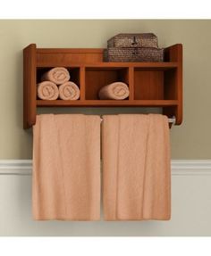 two towels are hanging on a shelf above the towel rack