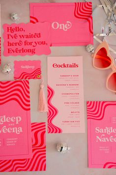 pink and red wedding stationery with silver confetti on the top, one for each bride