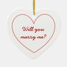 a ceramic heart ornament with the words will you marry me?