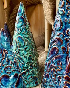 three blue vases sitting next to each other on a table