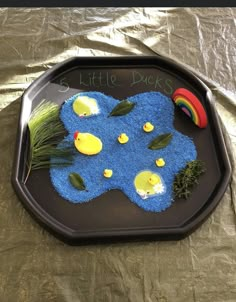 a tray that has some kind of blue thing on it with grass and other things