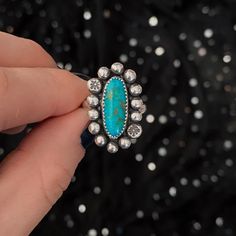 A single oval piece of American turquoise is the centerpiece of this statement ring. Centered with a large boarder of silver spheres, the stone is able to pop. Tiny star stamped details add an extra touch of magic. Patinated and polished, the back holds the Spell & Stone maker's mark. Size 7.5, can be sized up to a 8.5 if needed. ★ Handmade ★ .925 Sterling Silver ★ American Turquoise ★ Size 7.5 - Can Be Sized Up ★ Half Round Ring Band ★ 26mm x 15mm ★ Silver Spheres with Star Stamping ★ Oxidized Turquoise Rings Western, Country Girl Jewelry, Western Fashion Jewelry, Vintage Turquoise Jewelry, Handmade Turquoise Jewelry, Turquoise Statement Ring, December Birthstone Ring, Into The West, Western Accessories